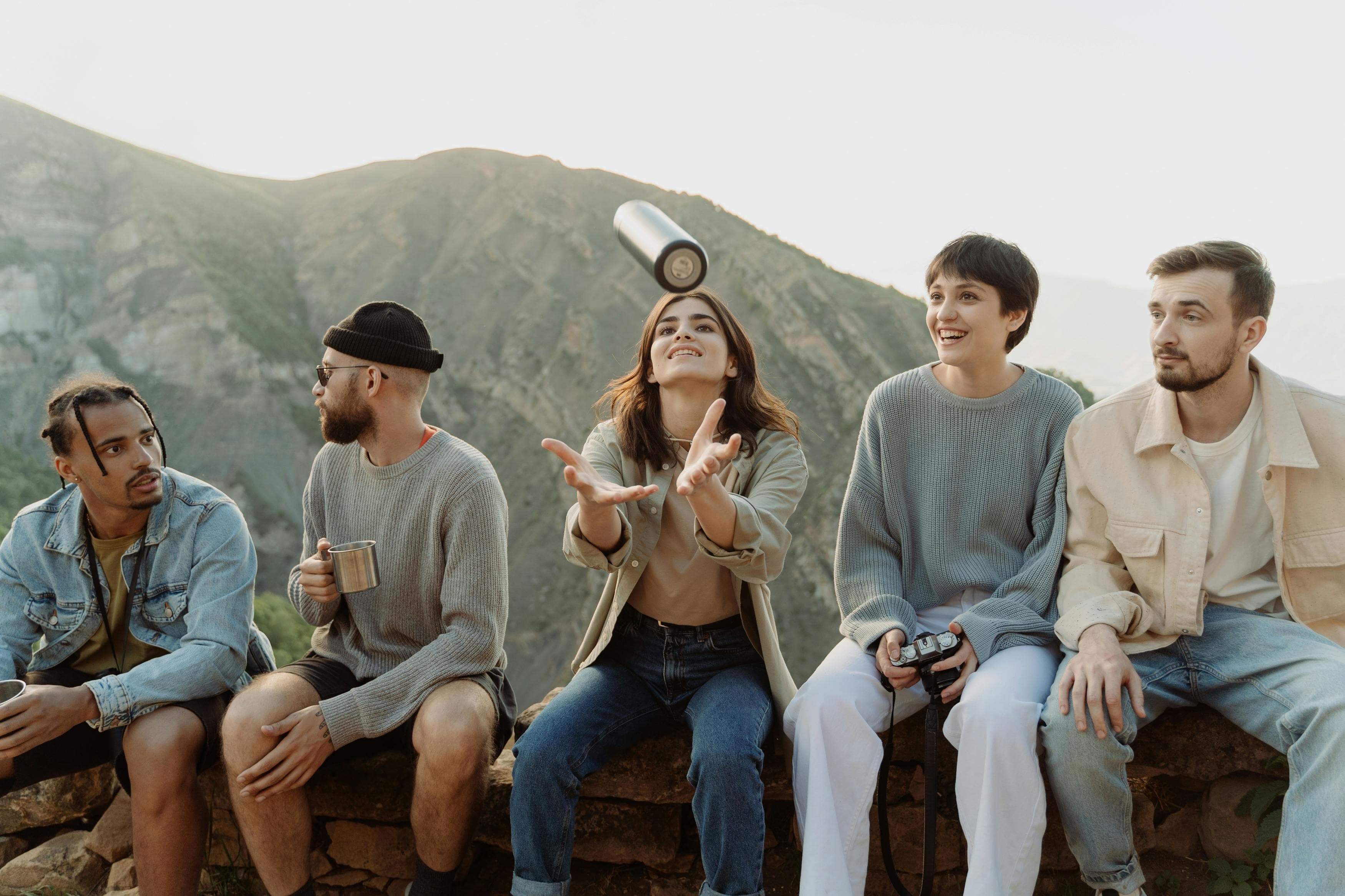 A group of young people sitting on a wall outdoors