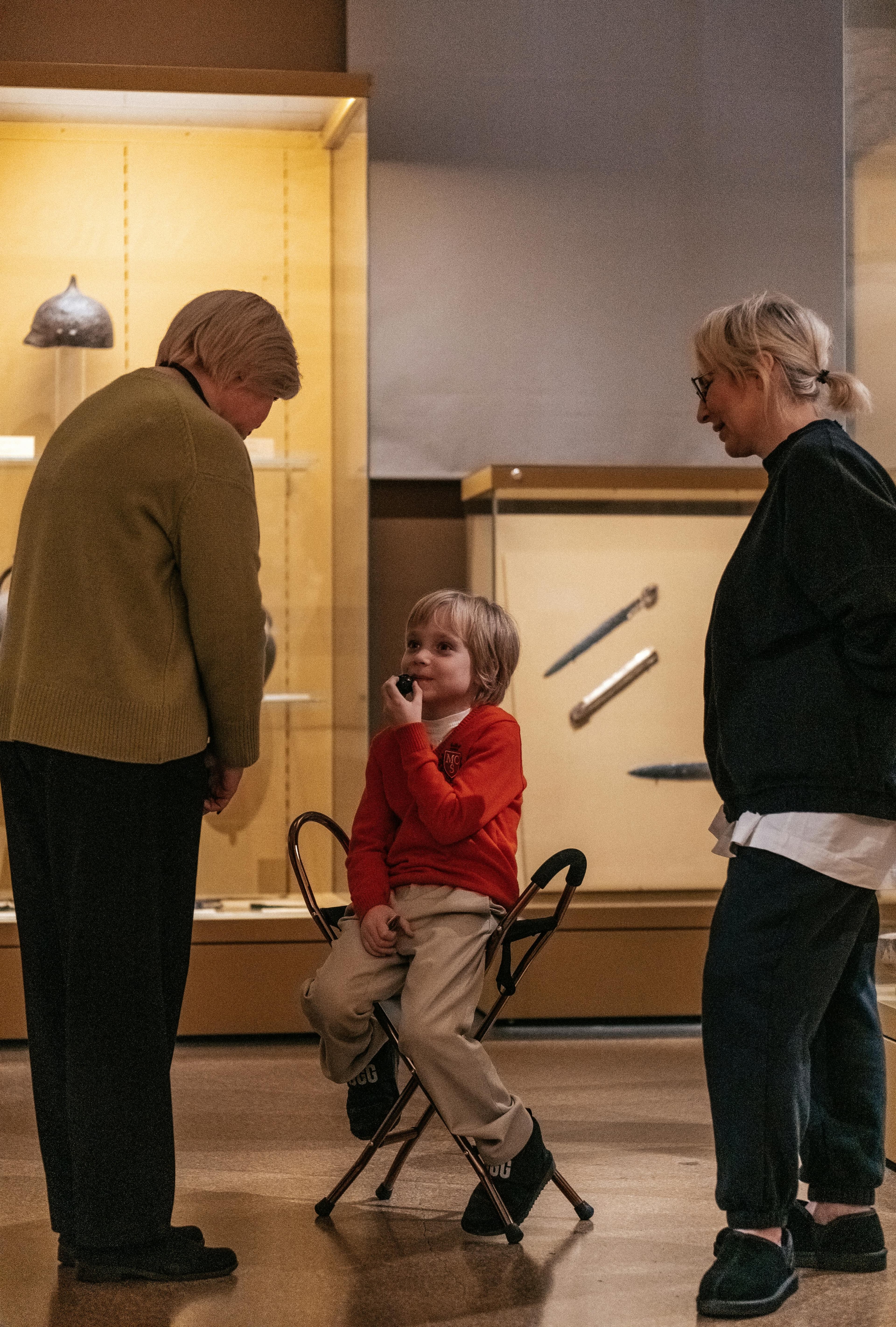 Two adults and a child in a museum