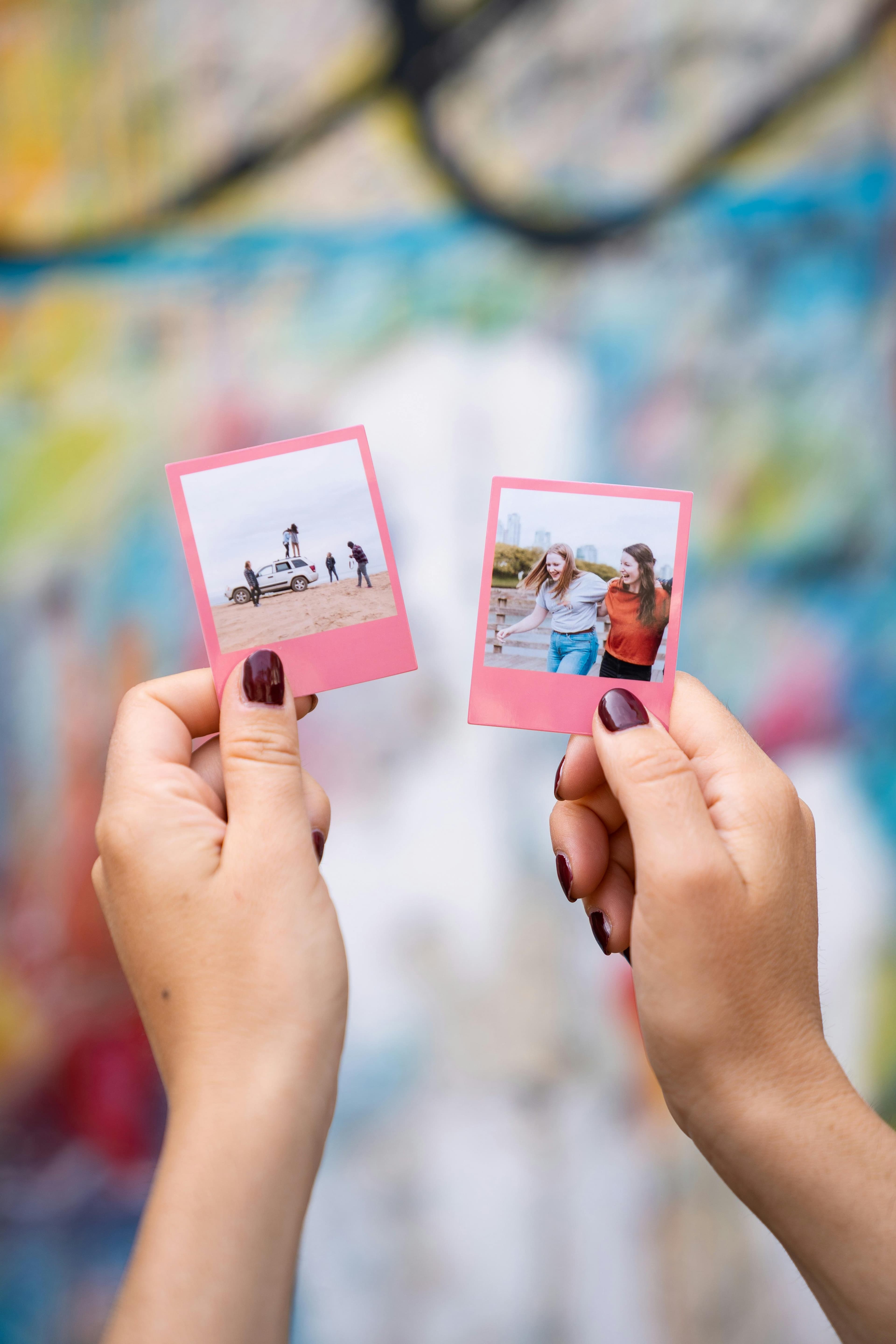 Two polaroid photos being held