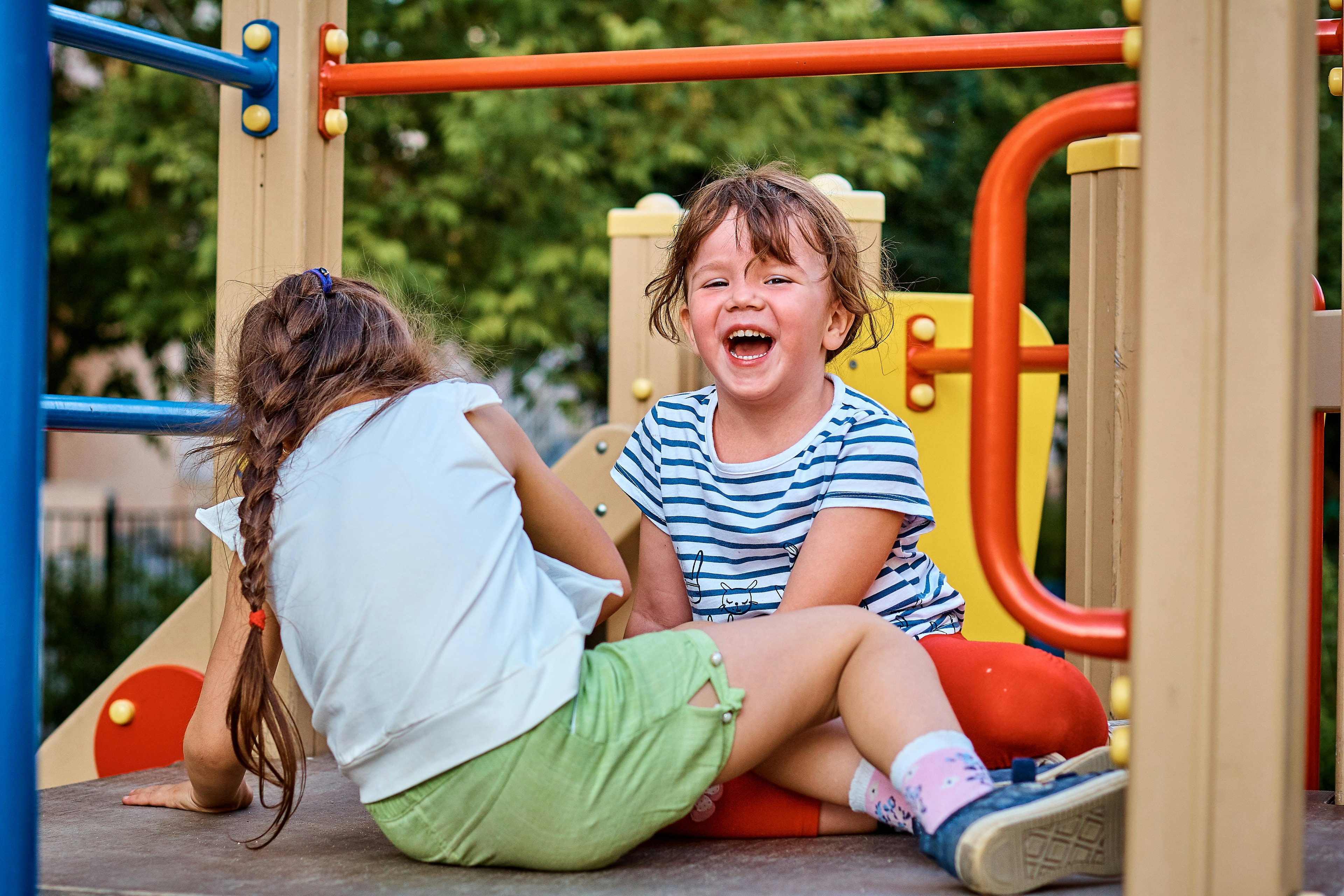 Two kids playing on the playground