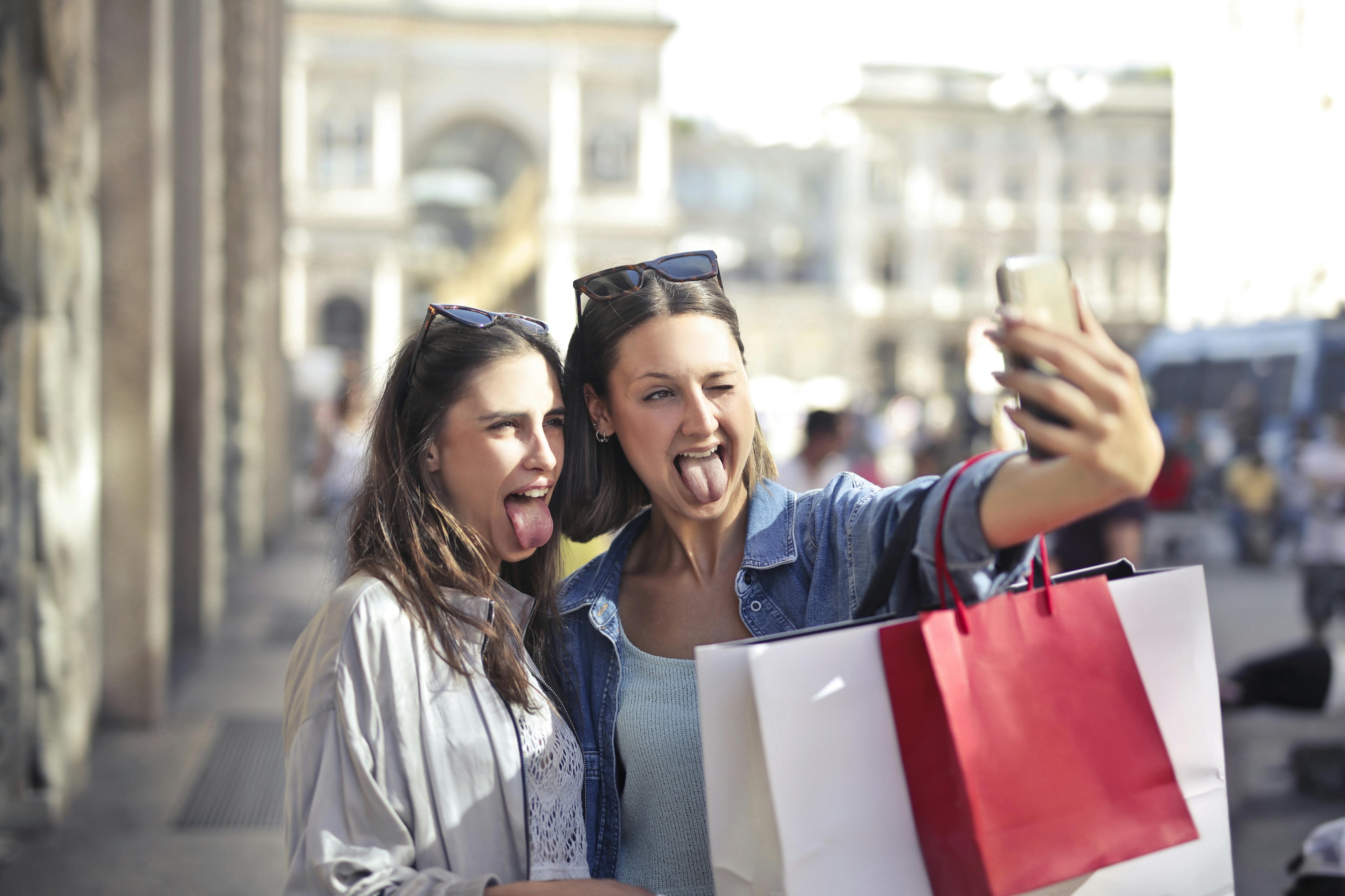 Two women posing for a selfie while out shopping