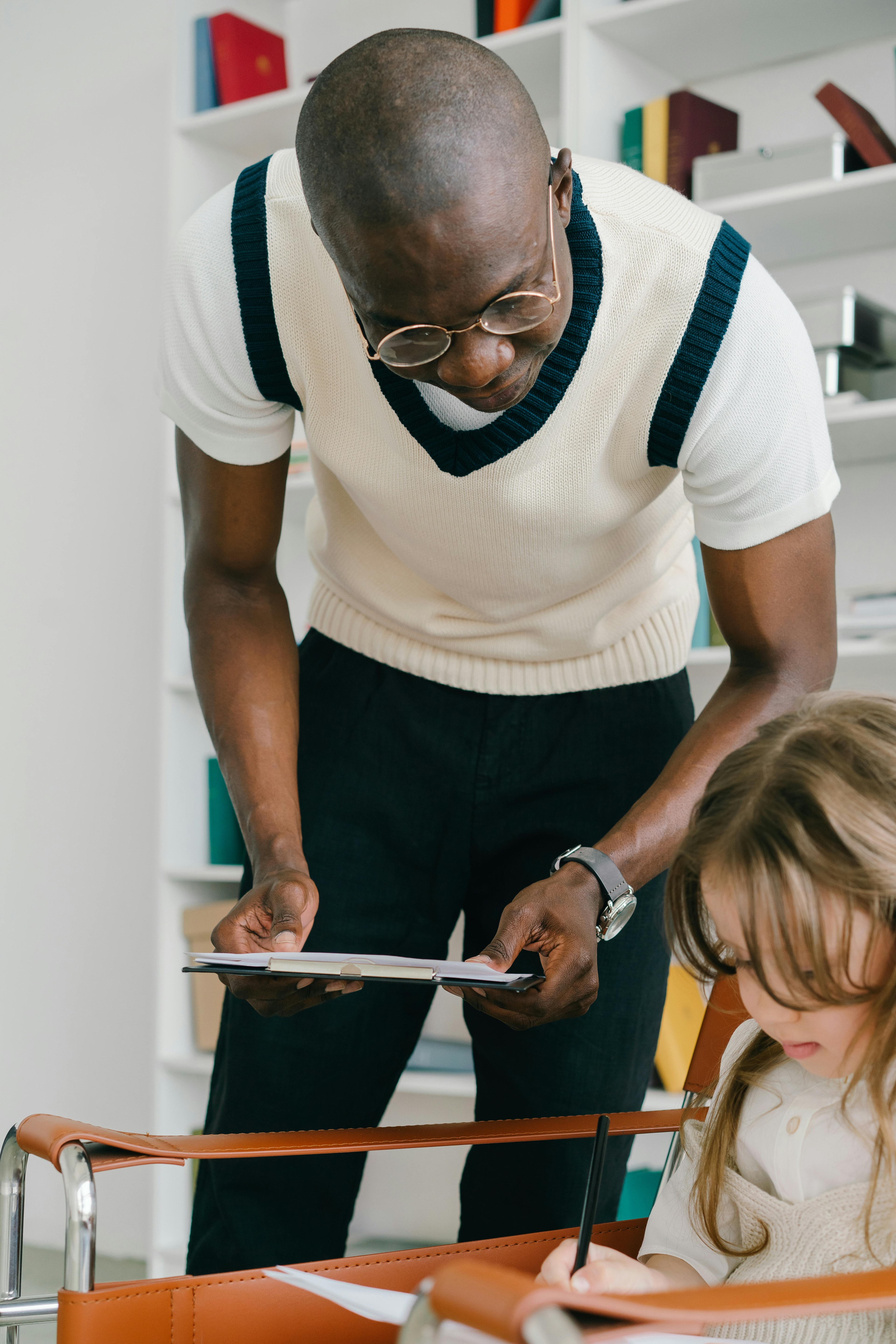 Teacher helping student