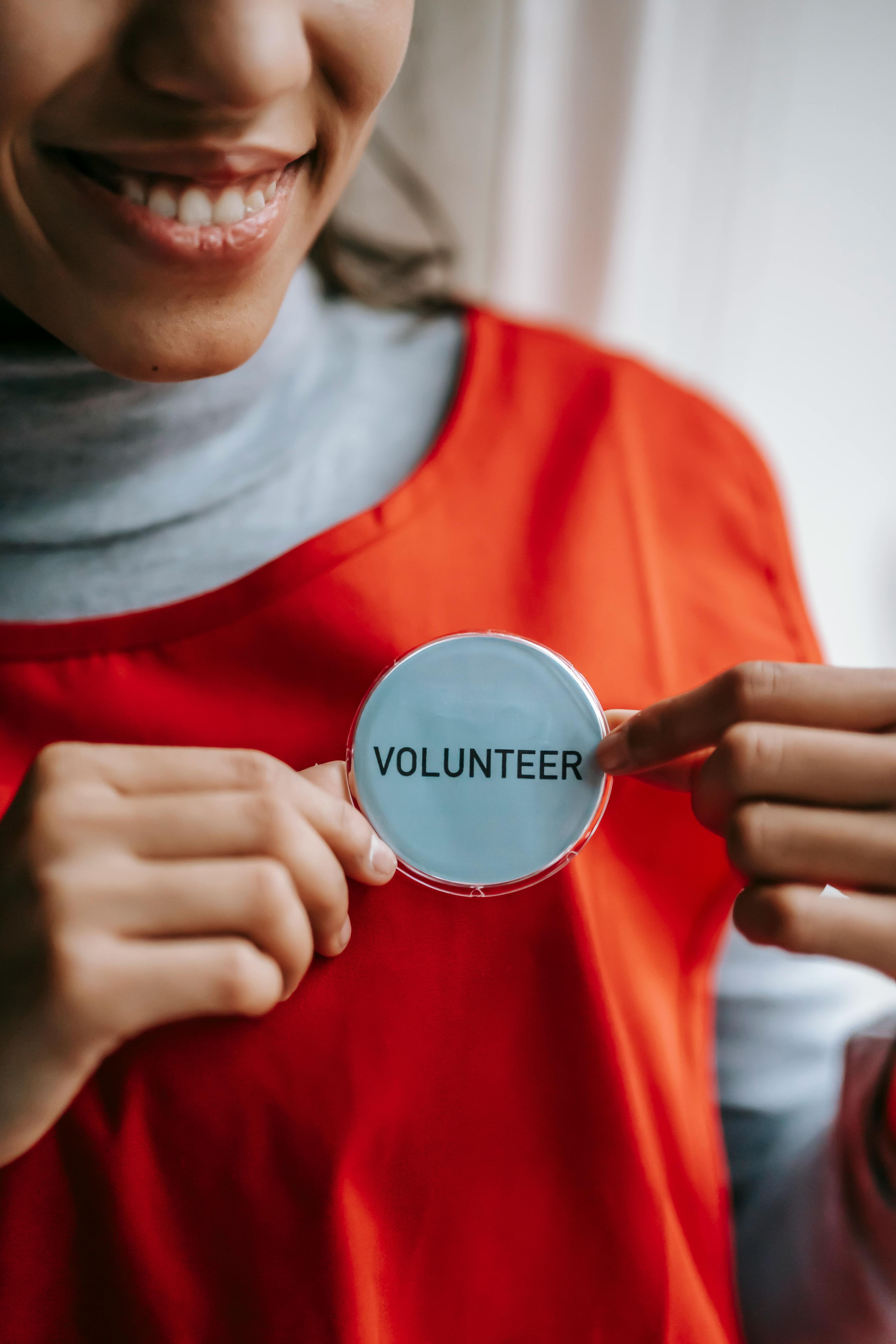 Someone putting on a volunteer badge