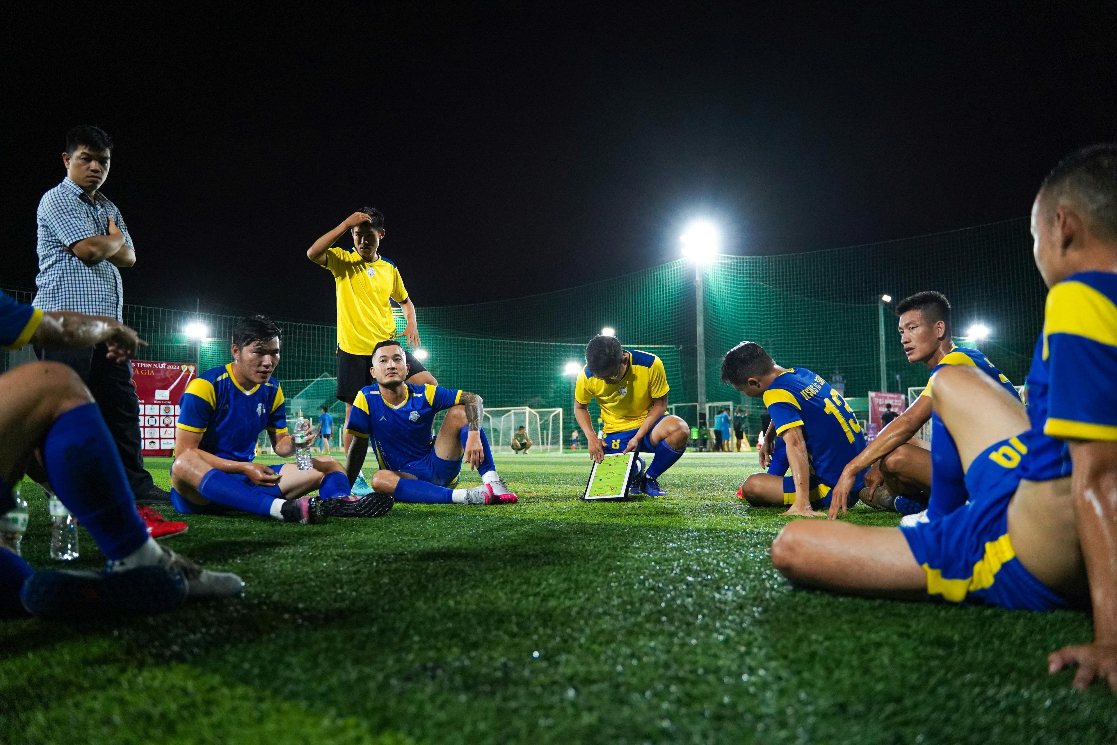 Soccer players sitting on field