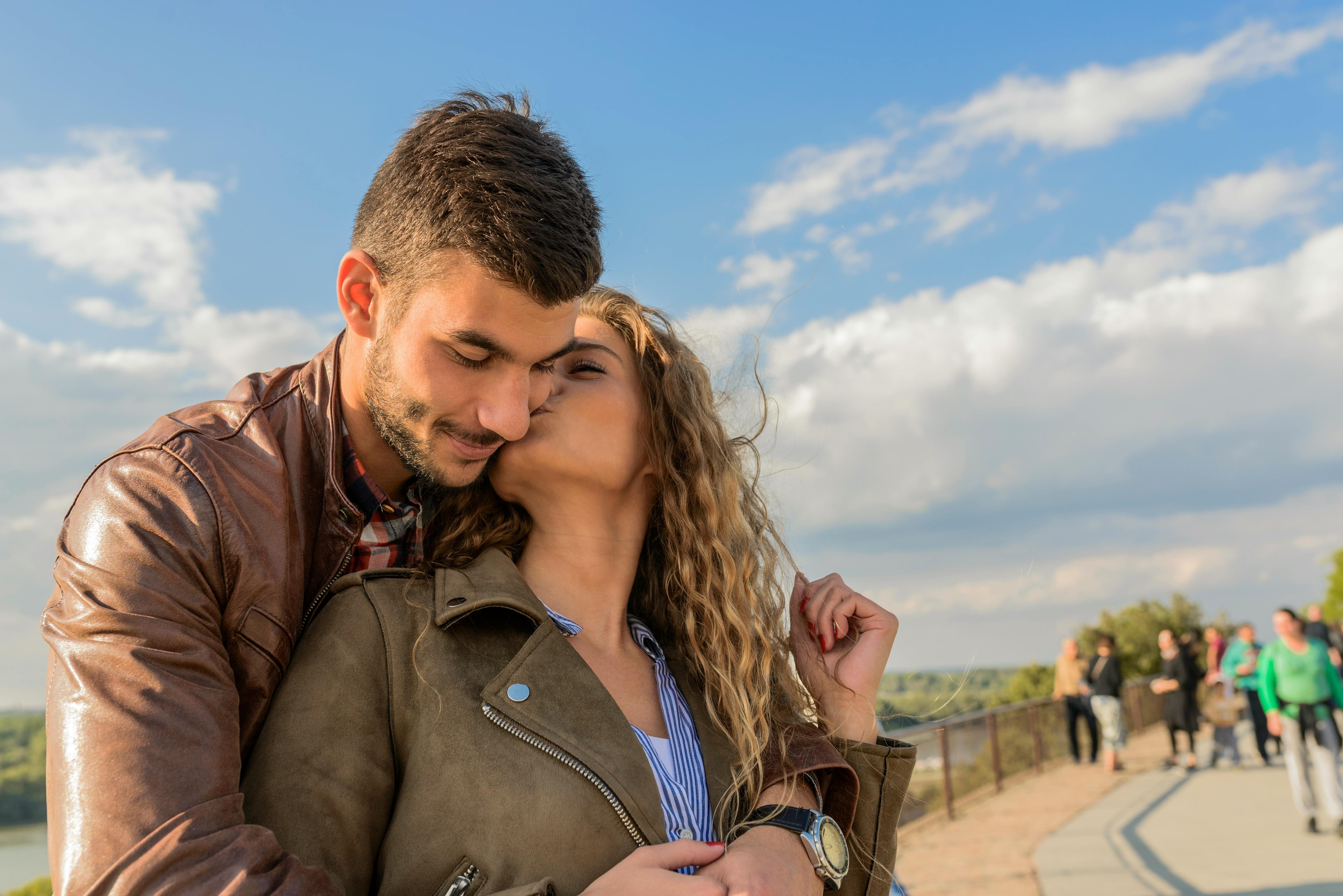 A woman kissing a man on the cheek