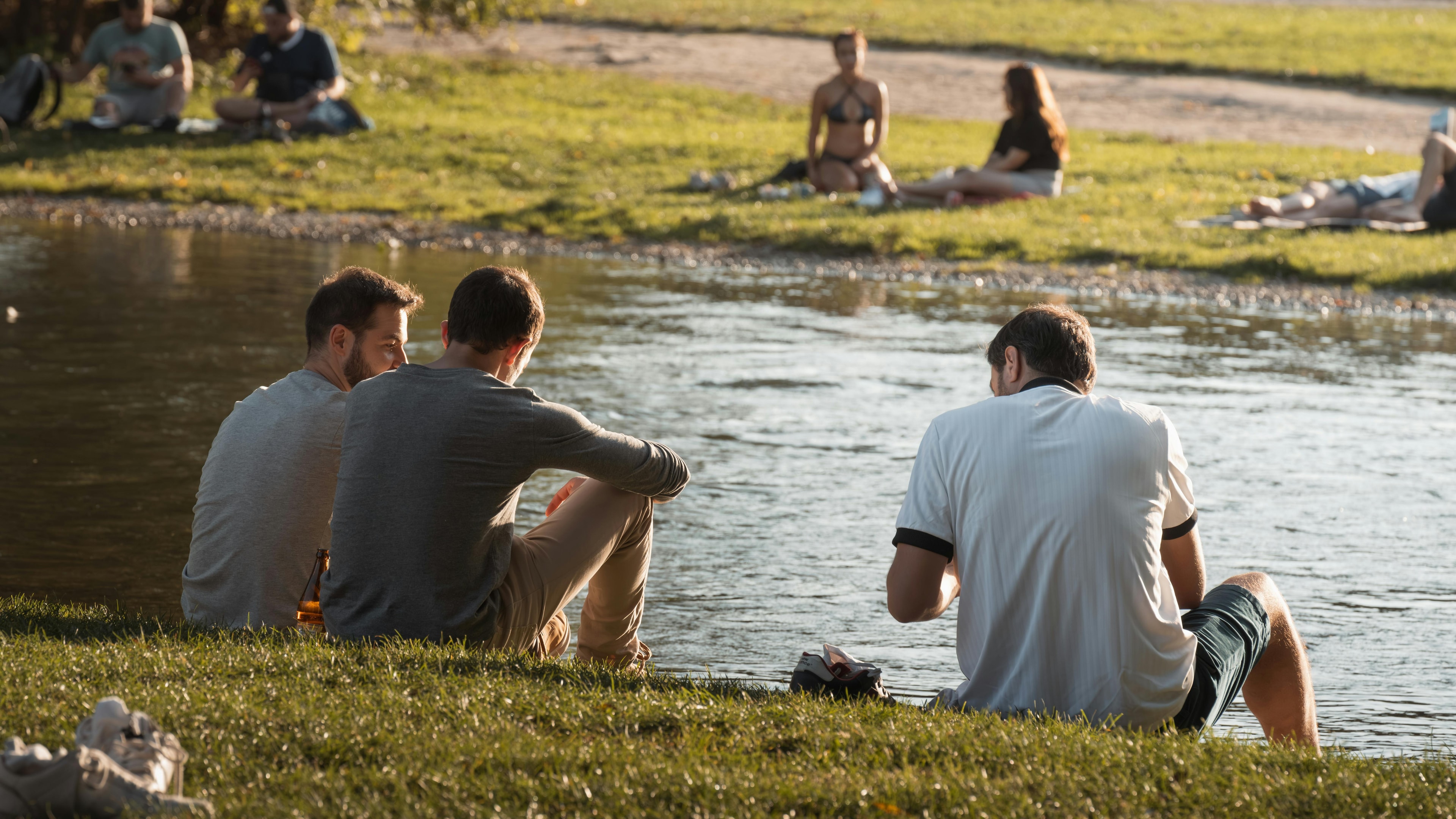 Guys hanging out by the water.